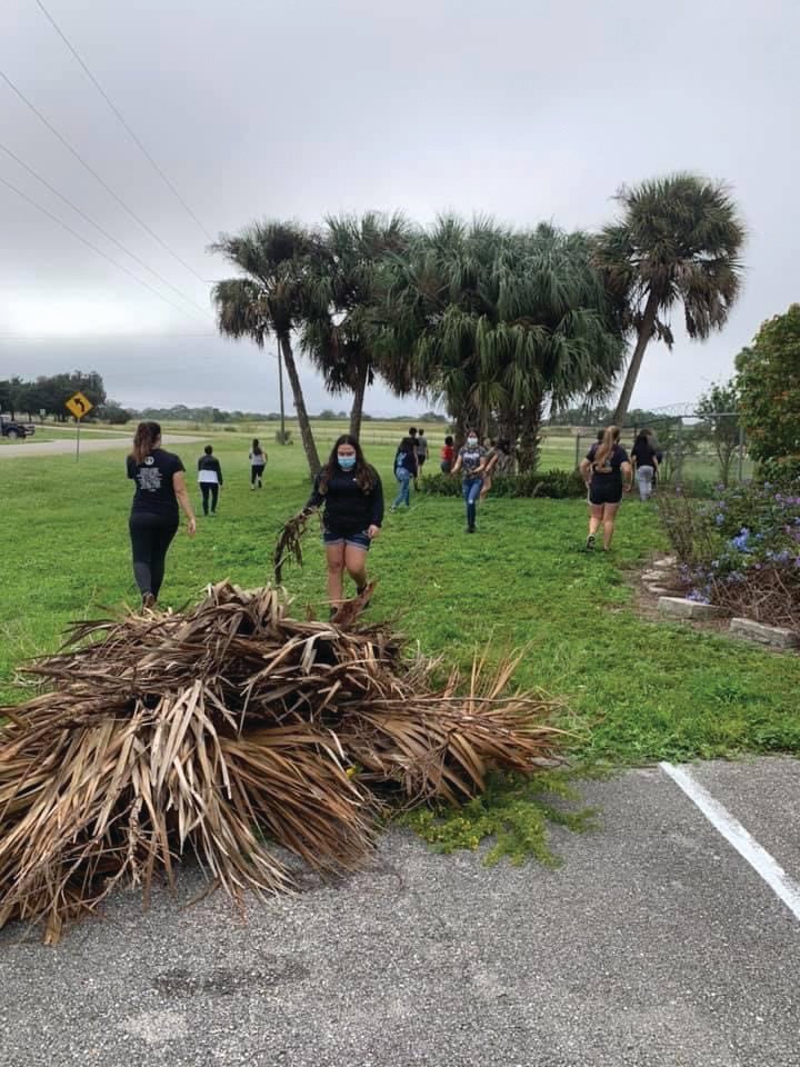 LHS National Honor Society Students voluntarily clean up palm fronds and other yard debris at Caloosa Humane Society.